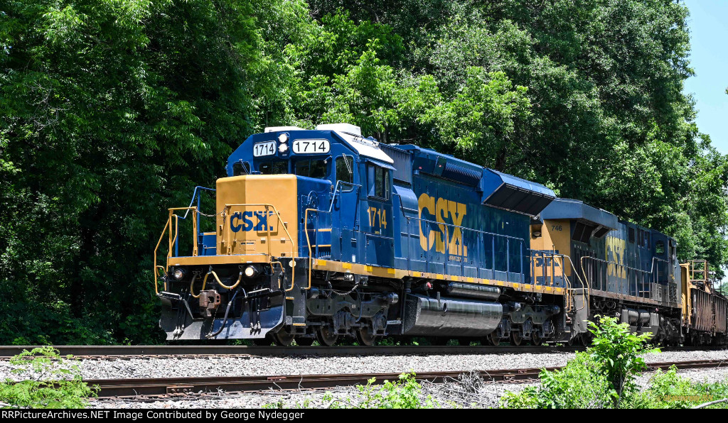CSX 1714 SD23T4 leads a loaded work train with welded rails